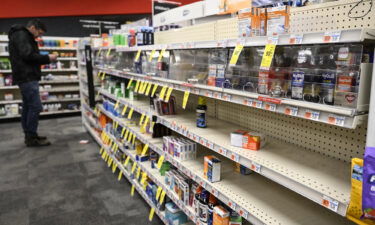 Shelves remain nearly empty near the section for children's medicine