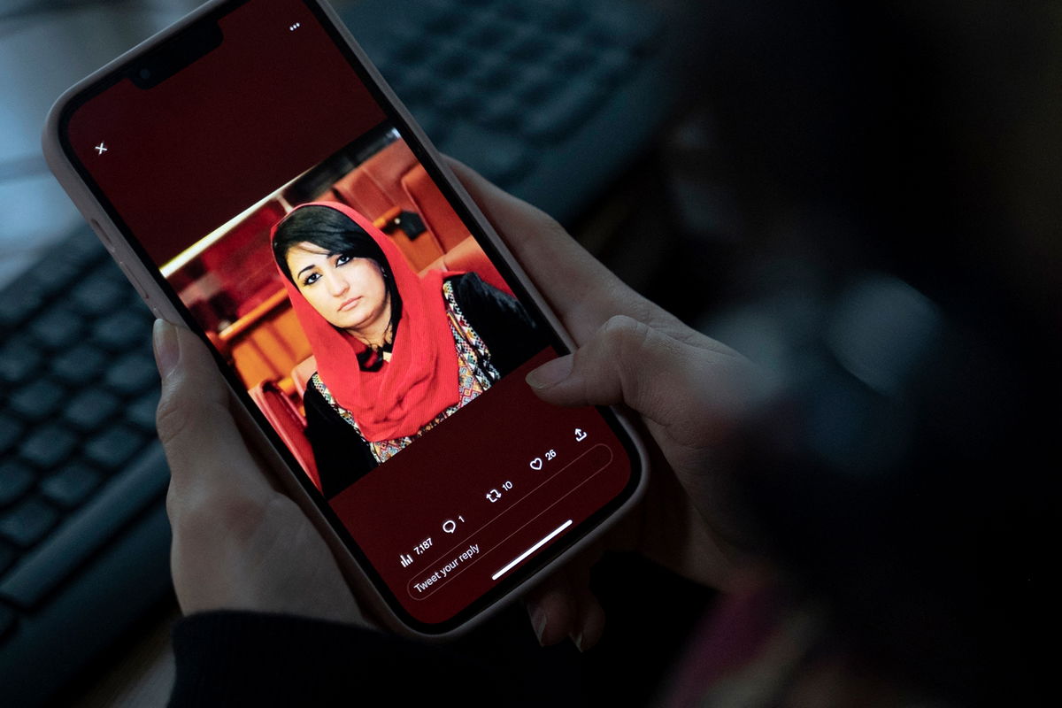 <i>Wakil Kohsar/AFP/Getty Images</i><br/>A woman looks at a picture of former Afghan lawmaker Mursal Nabizada on her mobile phone