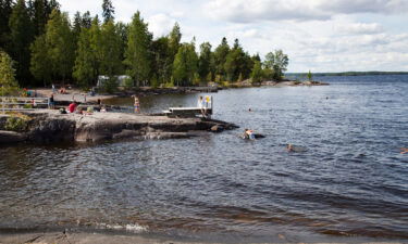 People enjoy nature at a lake in Finland.