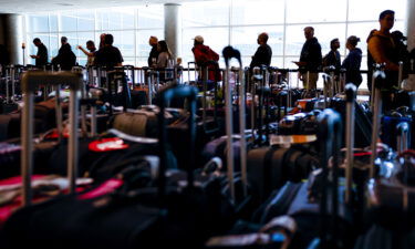 Southwest Airlines travelers wait in line in a baggage holding area at Denver International Airport on December 28