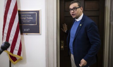 Rep. George Santos speaks with journalists outside his office on Capitol Hill on January 26.