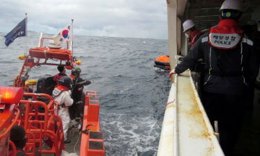 Eight people who were aboard a cargo ship that capsized off the coast of Japan have died and nine remain missing. Members of South Korea's coast guard are pictured searching for missing crew in waters between South Korea and Japan on January 25.