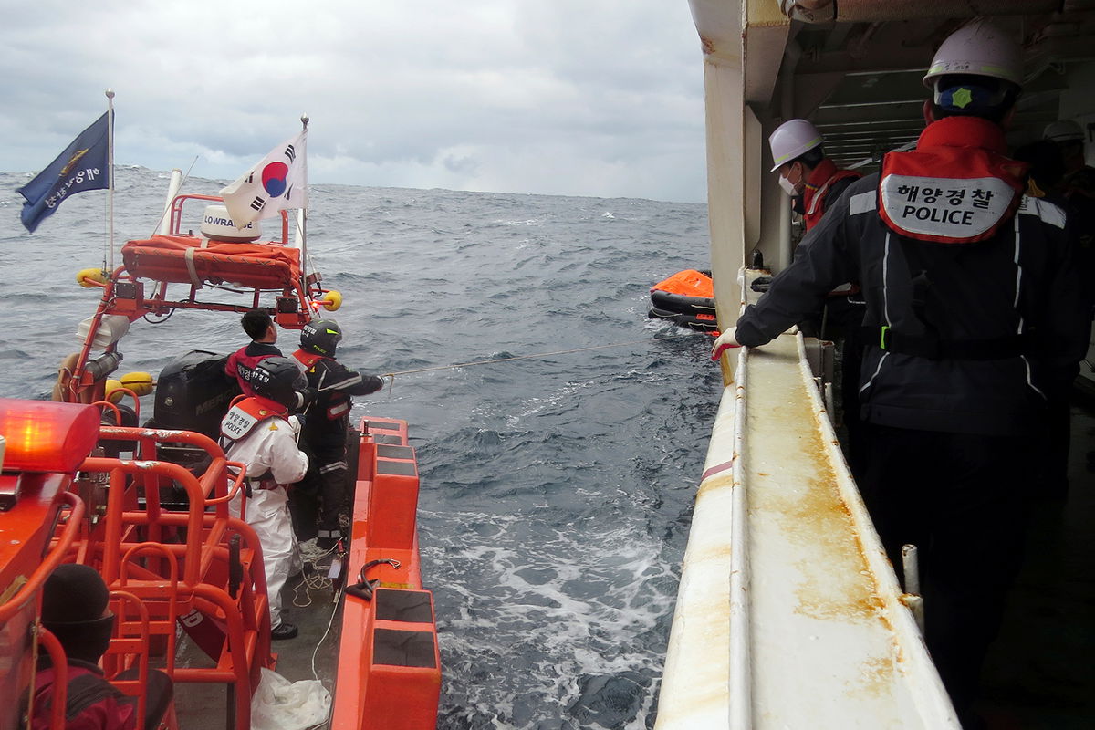 <i>The Korea Coast Guard/AP</i><br/>Eight people who were aboard a cargo ship that capsized off the coast of Japan have died and nine remain missing. Members of South Korea's coast guard are pictured searching for missing crew in waters between South Korea and Japan on January 25.