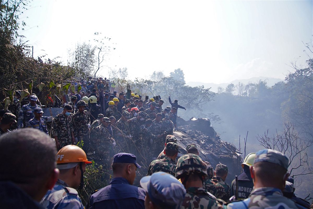 <i>Yunish Gurung/AFP/Getty Images</i><br/>Rescuers gather at the site of a plane crash in Pokhara.