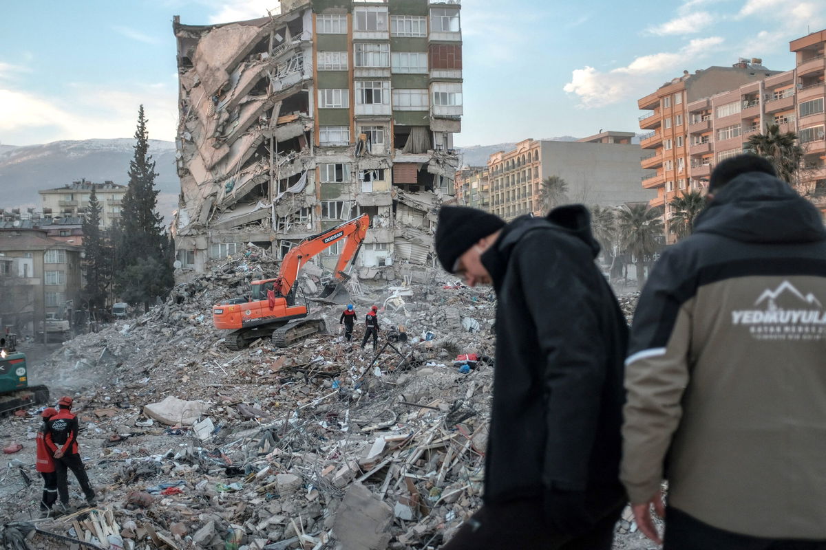 <i>Bulent Kilic/AFP/Getty Images</i><br/>Rescuers search through the rubble of a collapsed building in Kahramanmaras after the deadly earthquake.