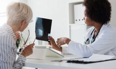 A physician talks with her patient while looking at her mammogram breast cancer screening. Screening rates declined during the Covid-19 pandemic.