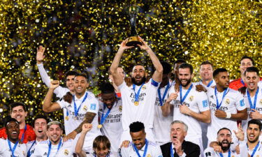 Karim Benzema of Real Madrid (C) raises the FIFA Club World Cup Trophy during the FIFA Club World Cup Morocco 2022 final match between Real Madrid v Al Hilal at Prince Moulay Abdellah on Saturday in Rabat