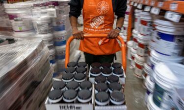 Home Depot said it will increase pay and benefits for front line hourly staff by $1 billion this year. Pictured is an employee at a Home Depot store in Livermore