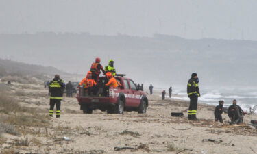 Rescuers arrive at the beach where bodies were found after a migrant shipwreck