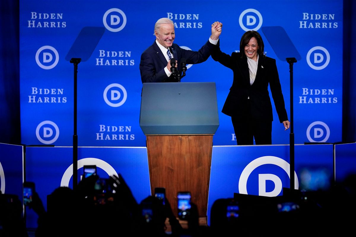 <i>Matt Rourke/AP</i><br/>President Joe Biden (left) and Vice President Kamala Harris hold their hands up at the Democratic National Committee winter meeting on February 3 in Philadelphia.