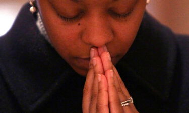 A young woman prays during an Ash Wednesday Mass at the Cathedral of Saint Matthew the Apostle in February of 2010 in Washington