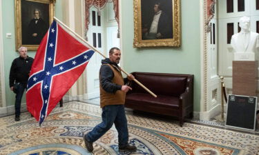 Kevin Seefried carries a Confederate battle flag on the second floor of the US Capitol on January 6