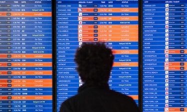 Travelers look at an information board showing flight cancellations and delays at Reagan National Airport in December 2022. The Department of Transportation's internal watchdog said on February 21 it is launching a probe into the spike in flight cancellations and delays.