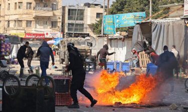 Palestinians clash with Israeli forces amid a raid in the West Bank city of Nablus