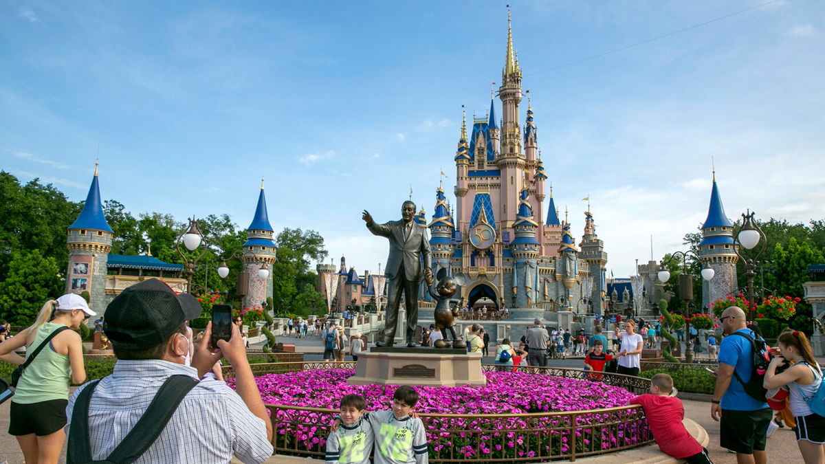 <i>Ted Shaffrey/AP</i><br/>People visit Magic Kingdom Park at Walt Disney World Resort in Lake Buena Vista