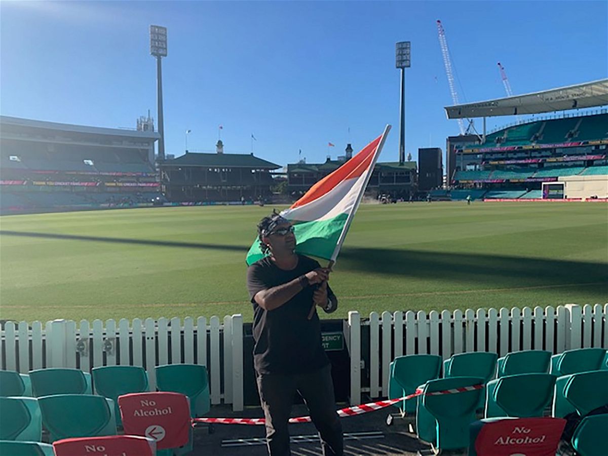 <i>Courtesy Krishna Kumar</i><br/>Krishna Kumar waves the Indian flag during the test match between Australia and India.