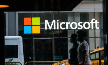 Pedestrians wearing protective masks walk past a Microsoft Technology Center in New York in July 2020. Microsoft announced it has agreed to partnerships with Nvidia and Nintendo.