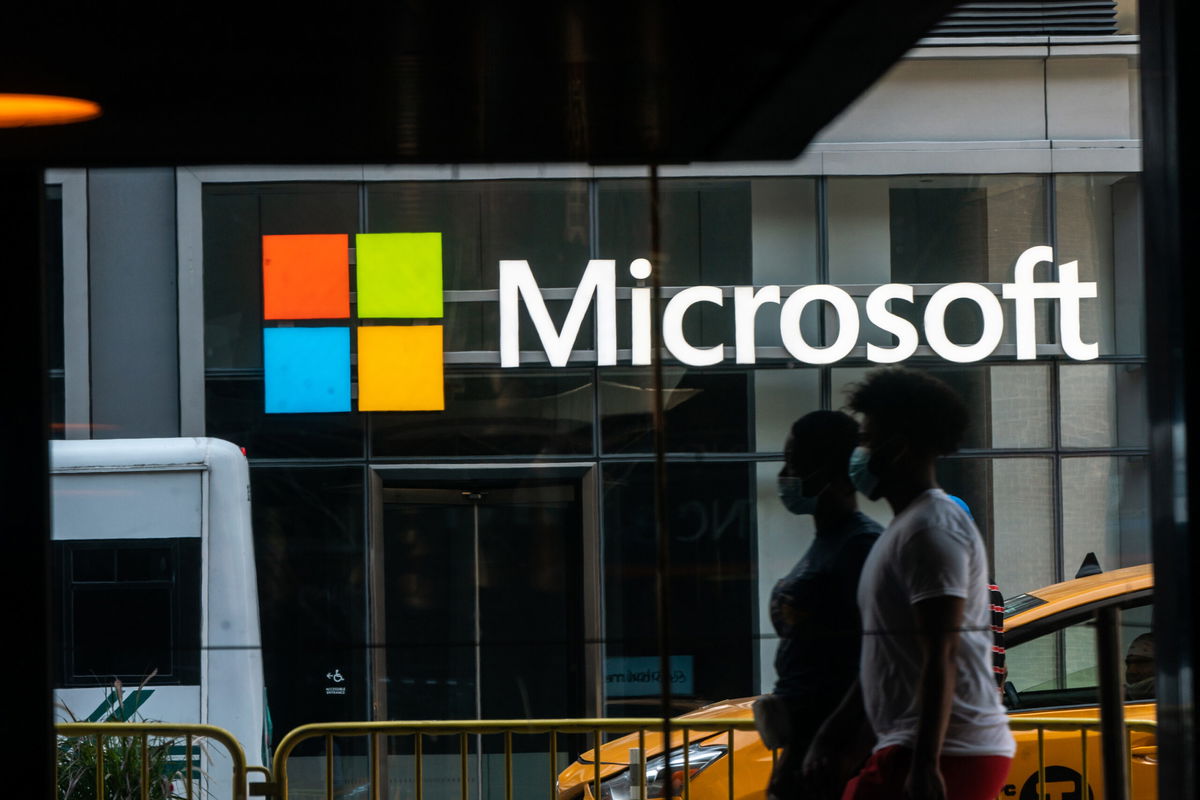 <i>Jeenah Moon/Bloomberg/Getty Images</i><br/>Pedestrians wearing protective masks walk past a Microsoft Technology Center in New York in July 2020. Microsoft announced it has agreed to partnerships with Nvidia and Nintendo.