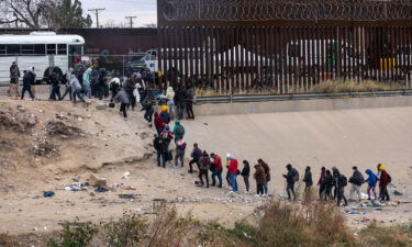 Migrants seeking asylum turn themselves in to US Border Patrol agents after wading across the Rio Grande to El Paso