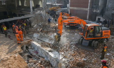 Security personnel and rescue workers search for survivors amid the debris of the mosque in Peshawar on January 31.