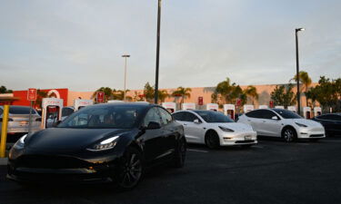 A Tesla electric vehicle departs after charging at a supercharger location in Hawthorne