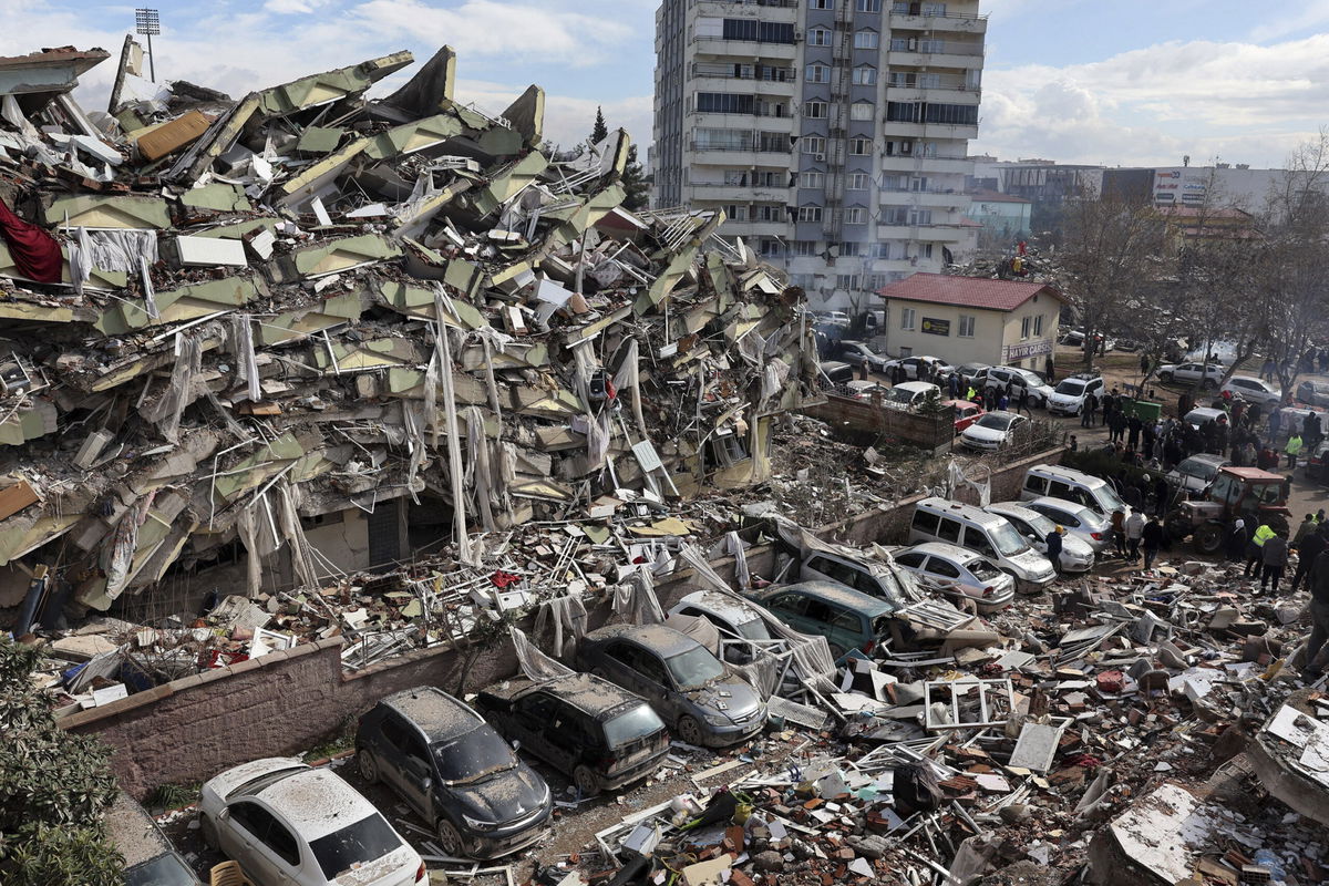 <i>Adem AltanAFP/Getty Images</i><br/>Rescuers and civilians look for survivors under the rubble of collapsed buildings in Kahramanmaras