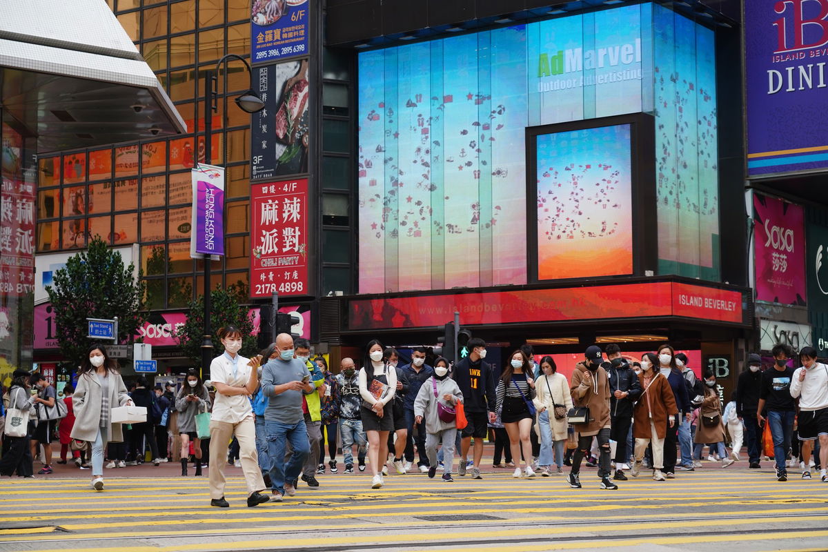 <i>Zhang Wei/China News Service/VCG/Getty Images</i><br/>Officials expect Hong Kong's economy to grow between 3.5% and 5.5% this year. People here walk on a street in Causeway Bay on January 2