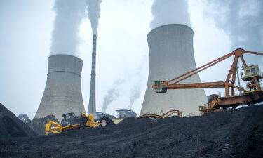 A bulldozer pushes coal onto a conveyor belt at the Jiangyou Power Station on January 28