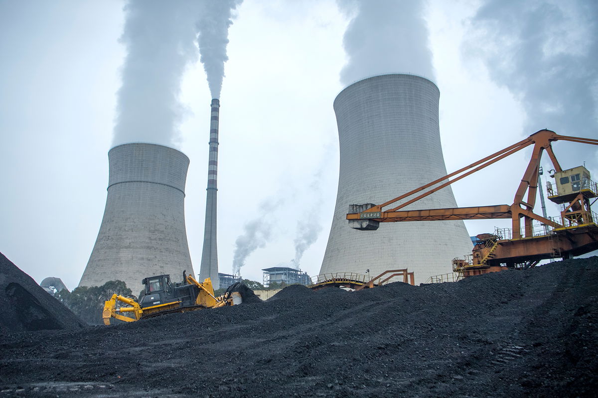 <i>Liu Zhongjun/China News Service/Getty Imsges/File</i><br/>A bulldozer pushes coal onto a conveyor belt at the Jiangyou Power Station on January 28