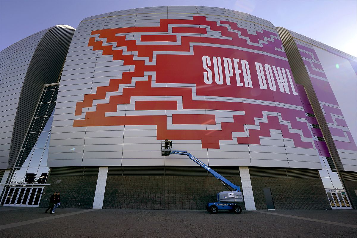 Workers prepare for the NFL Super Bowl LVII football game outside State Farm Stadium on February 1 in Glendale, Arizona. Of the four crypto or crypto-affiliated companies that advertised in the Super Bowl last year, one (FTX) has collapsed completely.