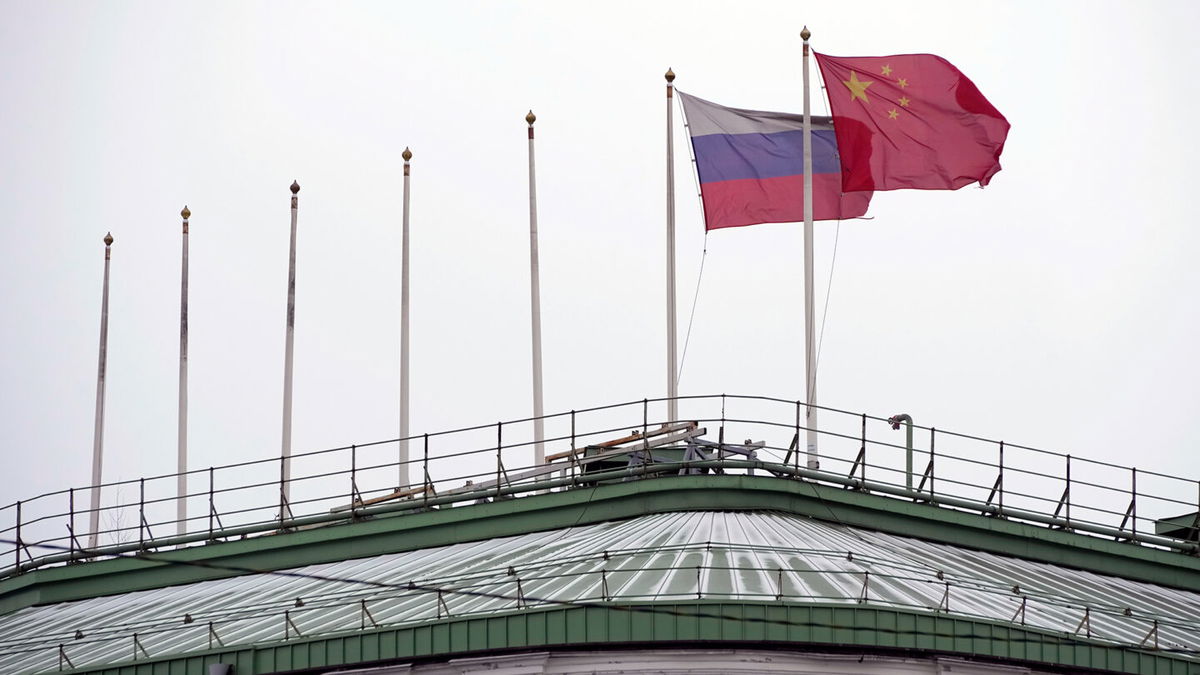 <i>Dmitri Lovetsky/AP</i><br/>The flags of Russia and China flutter on the roof of a hotel in central St. Petersburg