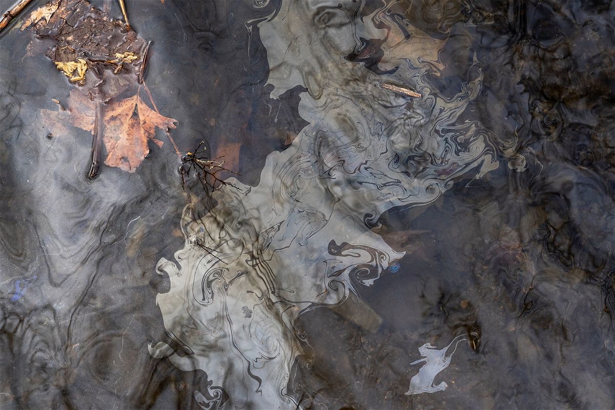 <i>Michael Swensen/Getty Images</i><br/>Petroleum based chemicals float on the top of the water in Leslie Run creek after being agitated from the sediment on the bottom of the creek on February 20