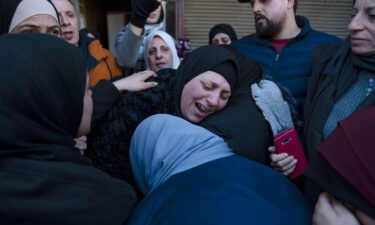 Ghorud Bustami cries while taking the last look at the body of her son Amir Bustami