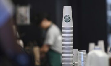 Baristas prepare orders at a Starbucks coffee shop in New York