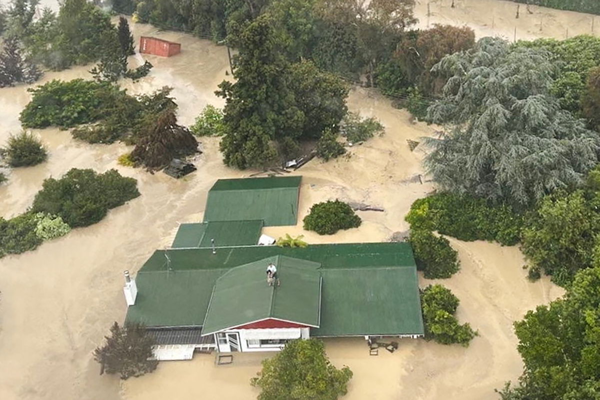 <i>New Zealand Defence Force/Reuters</i><br/>An NH90 helicopter and crew recover people from the rooftops of their homes in Esk Valley