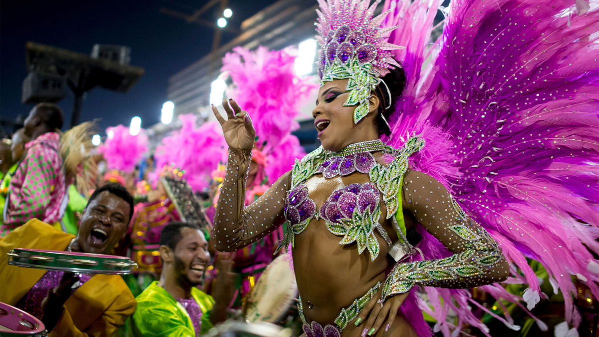 <i>Buda Mendes/Getty Images</i><br/>Paraders head to the Sambadrome on March 2