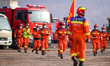 Rescue workers gather at the site.