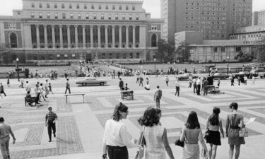 Students walk to classes on the first day of the Fall semester at Columbia University in New York on September 26