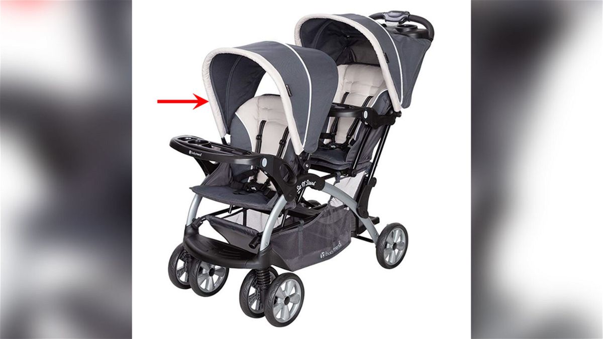 A red arrow has been placed on this image by the U.S. Consumer Product Safety Commission. The Baby Trend Sit N' Stand Double stroller, model number beginning SS76.