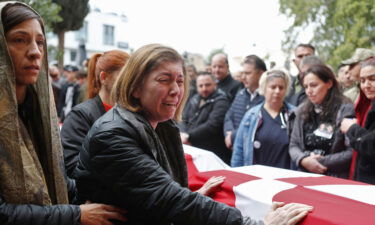 Mourners attend the funeral in Famagusta