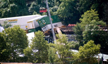 Workers in a gondola look over derailed freight cars in August of 2018 on Pittsburgh's south side.