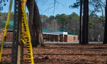 Police tape hangs from a sign post outside Richneck Elementary School following a shooting on January 7 in Newport News