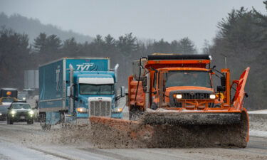 Snow plows trucks clear snow and ice from Interstate highway 93 during a winter storm in Hooksett