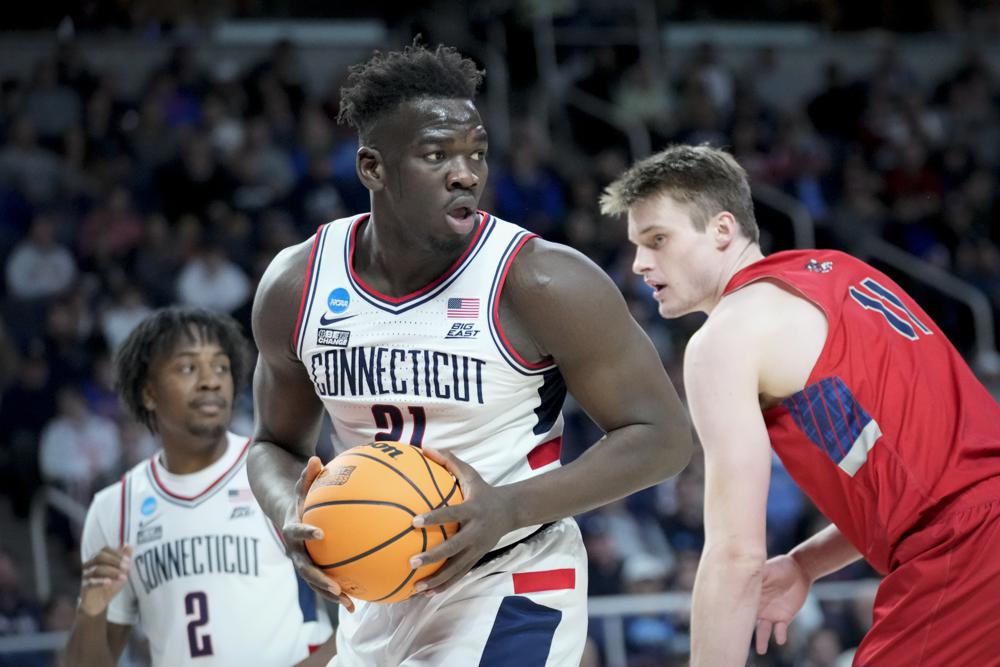 Connecticut's Adama Sanogo (21) looks to pass after rebounding against St. Mary's Mitchell Saxen (11) in the first half of a second-round college basketball game in the NCAA Tournament, Sunday, March 19, 2023, 