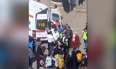 A medical team loads a patient onto ambulance in Halban Zaker Girls' School in the Iranian city of Ardabil.