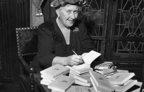 Agatha Christie signs copies of her books in around 1950. Her works are revised to remove racist references and other language considered offensive to modern audiences.