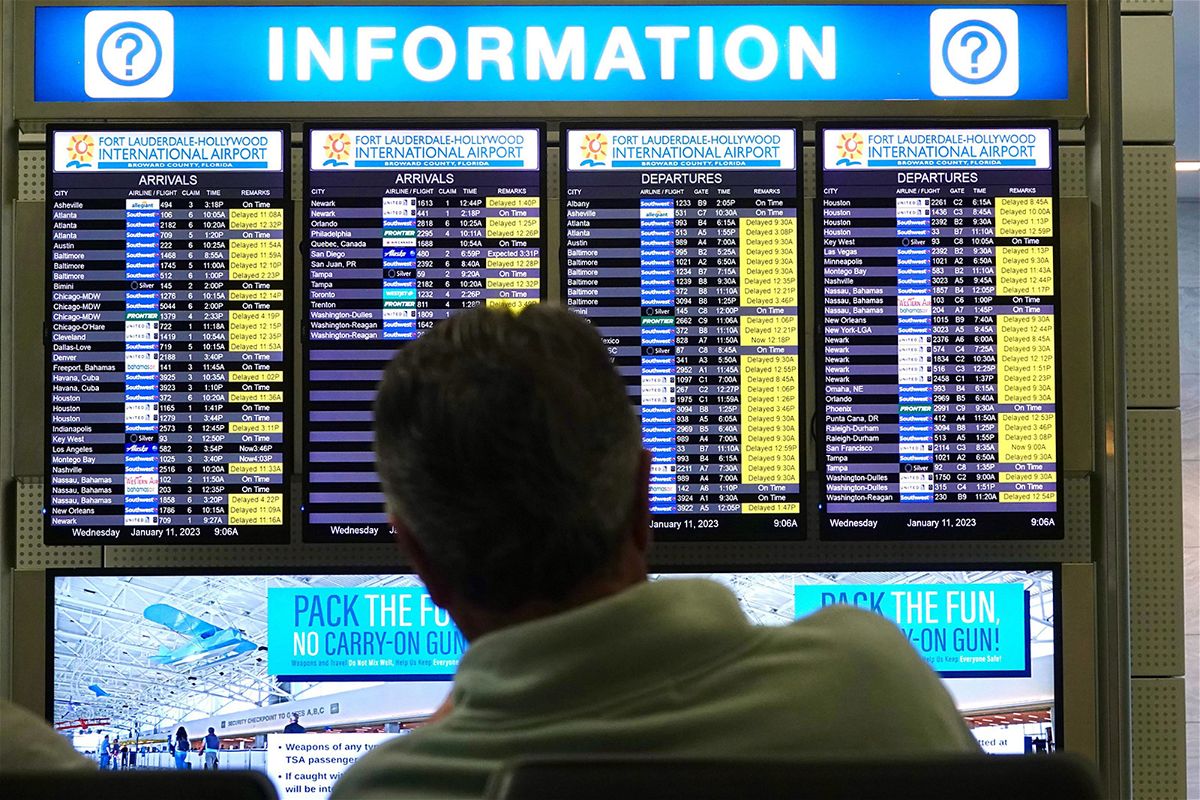 <i>Joe Cavaretta/Sun Sentinel/Tribune News Service/Getty Images</i><br/>A man looks at the flight information board at Fort Lauderdale-Hollywood International Airport after an early morning FAA system outage caused delays across the country in January. Such incidents are making some people think twice before booking flights.