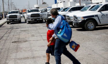 People walk outside the Attorney General's Office of the State of Tamaulipas ahead of the transfer of the bodies of two of four Americans kidnapped by gunmen to the U.S. border.