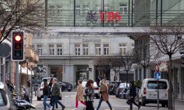 A Credit Suisse Group AG bank branch beyond a UBS Group AG office building walkway in Zurich