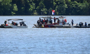 Emergency personnel remove debris from a plane crash in Percy Priest Lake on May 30